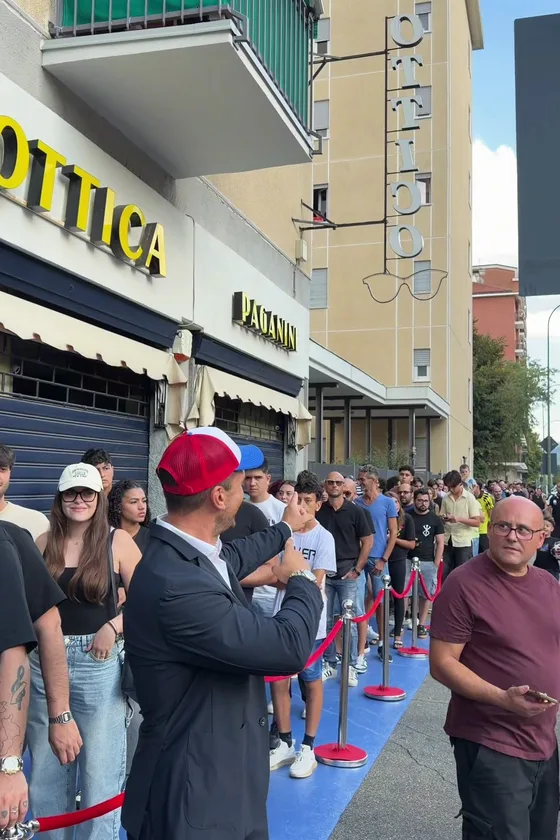 Guests queuing along the red rope, waiting for the doors to open
