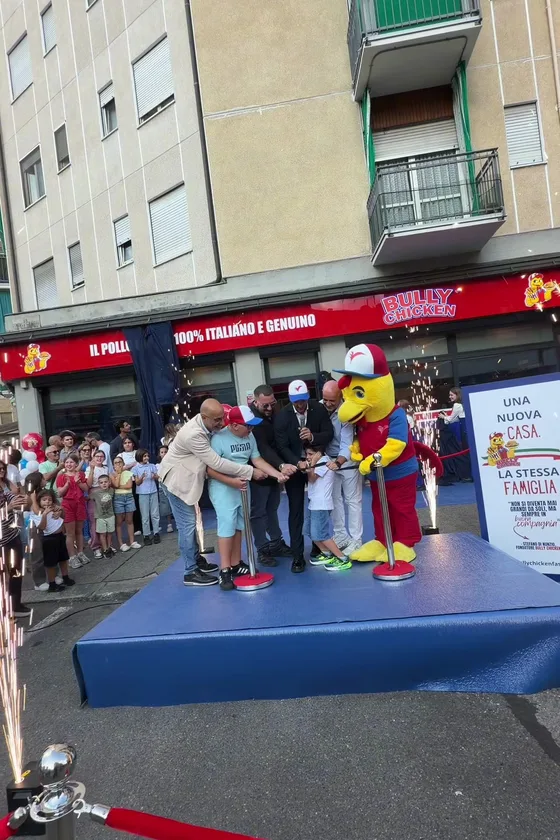 The ribbon cutting on stage in front of the crowd